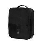 A black travel packing cube with a top carry handle, featuring a mesh upper section, a zippered lower compartment, and a small black brand patch on the front.