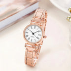 Rose gold watch with a white face on a light background