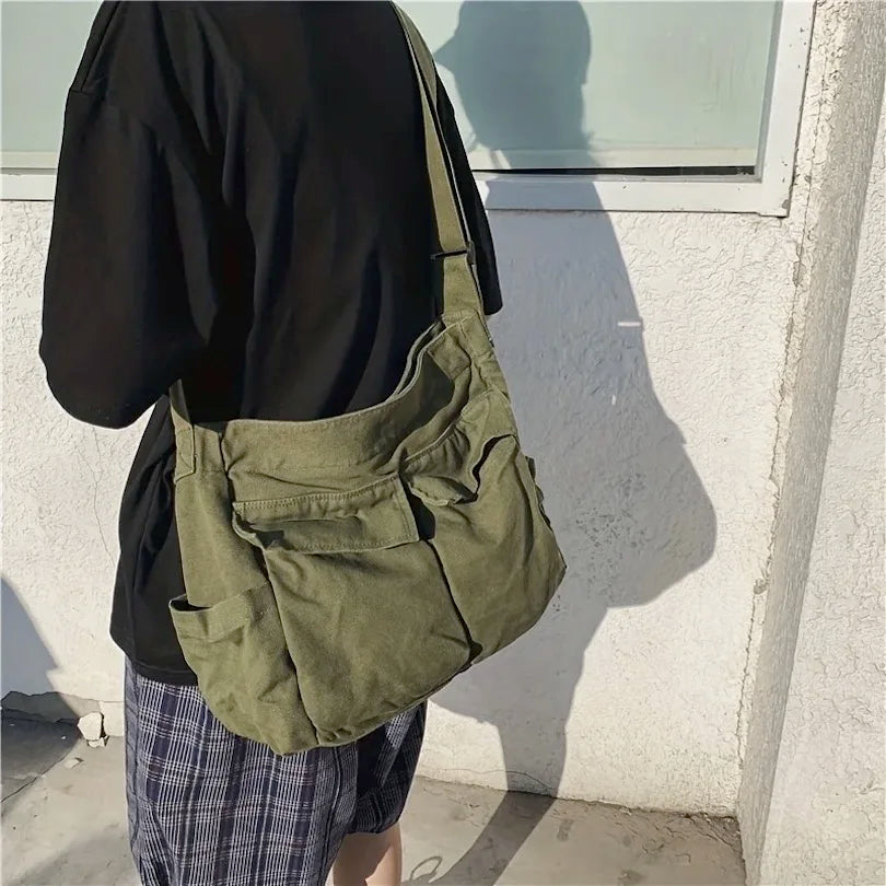 Person wearing a green bag against a light-colored wall