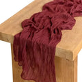 Red fabric draped over a wooden surface
