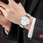 Men's silver-tone quartz wristwatch with stainless steel band and white multi-dial face, styled with a formal suit – EMESA HOME.