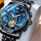 Luxury watch with blue face and black metal strap on a white cushion, brand 'OLEVS' visible.