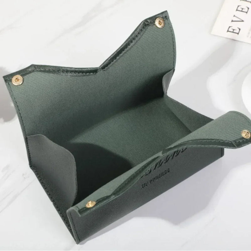 Green fabric pouch with gold buttons on a white background