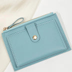 Blue wallet with a gold zipper on a light background