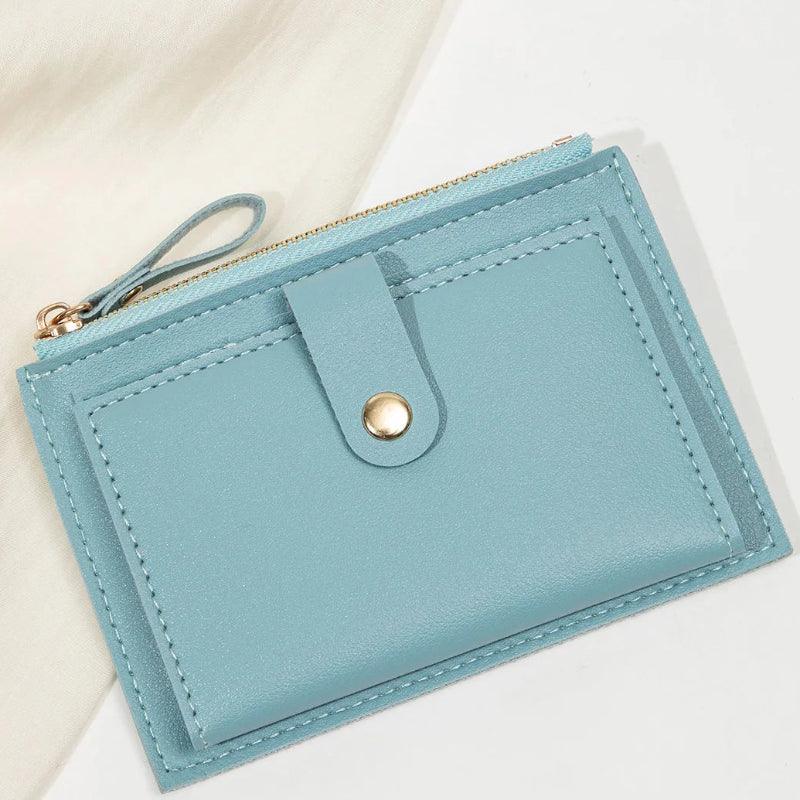 Blue wallet with a gold zipper on a light background