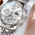 Silver wristwatch with detailed face on a white cushion, brand 'OLEVS' visible