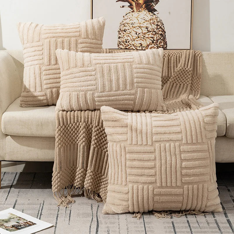 Beige textured throw blanket and pillows on a sofa with a pineapple decor item.