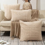 Beige textured throw blanket and pillows on a sofa with a pineapple decor item.