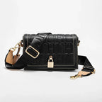 Black handbag with gold accents on a white background