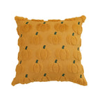 Yellow pillow with pumpkin pattern on a white background