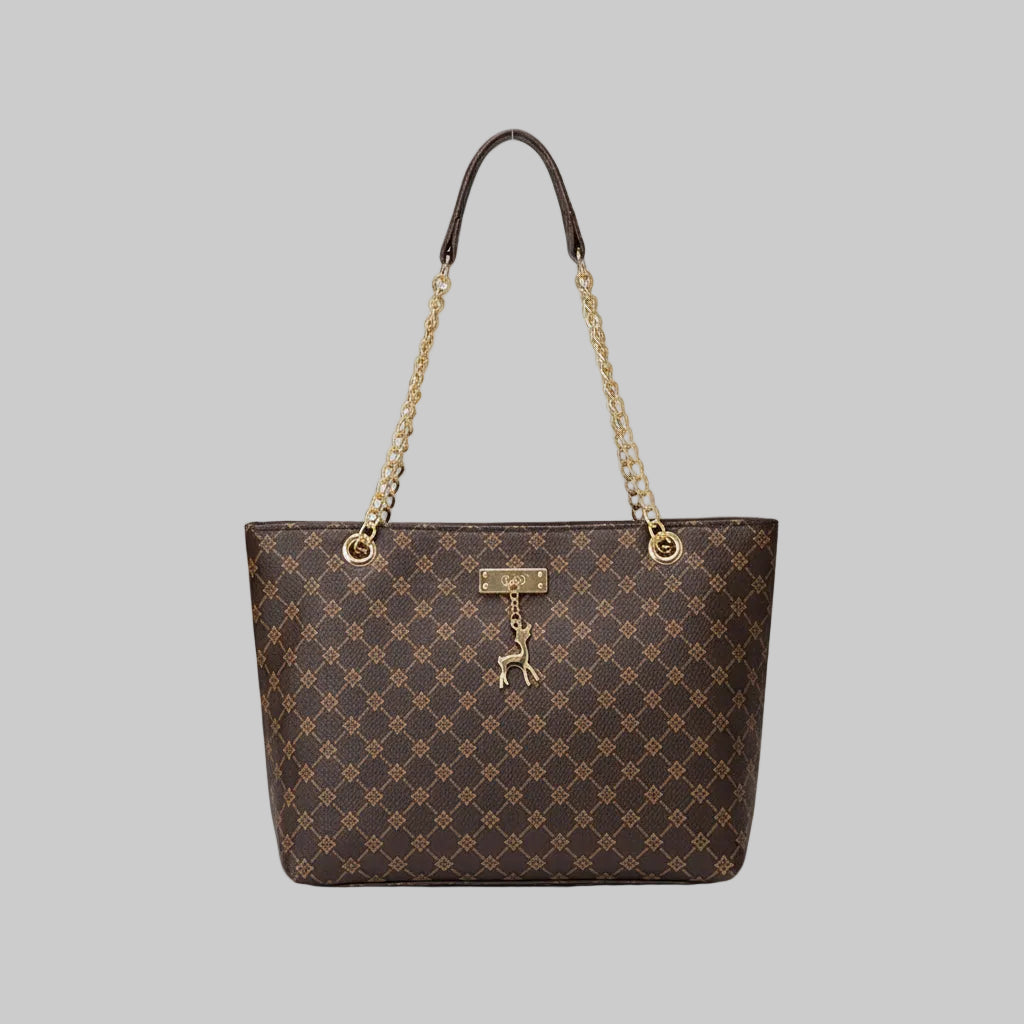 Designer handbag with gold chain and clasp on a wooden surface
