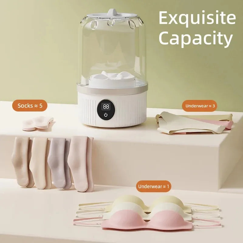 White sterilizer with clothes on a white surface and green background, labeled 'Exquisite Capacity'.
