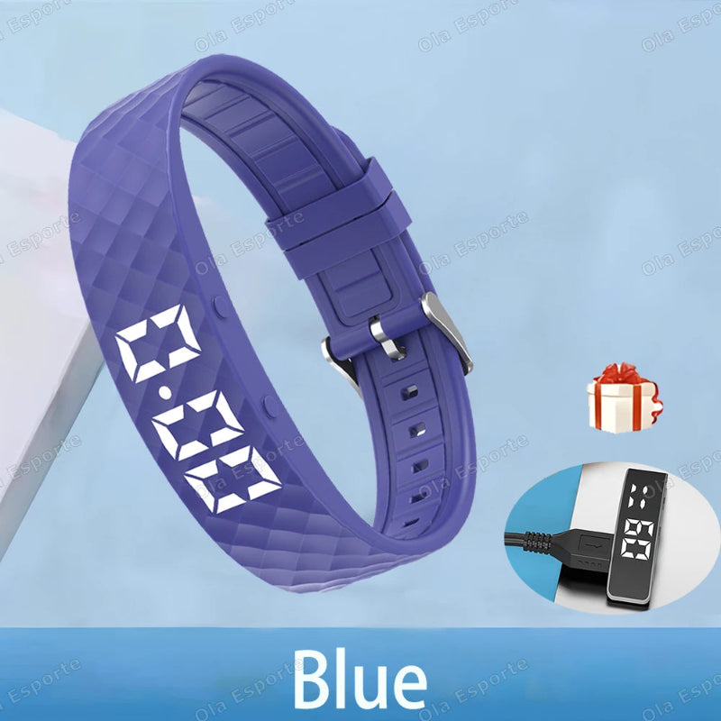 Blue digital wristband with charging cable on a light blue background