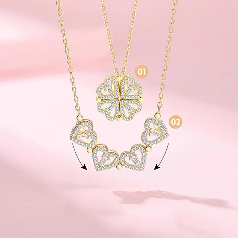 Gold necklace with heart-shaped pendants on a pink background