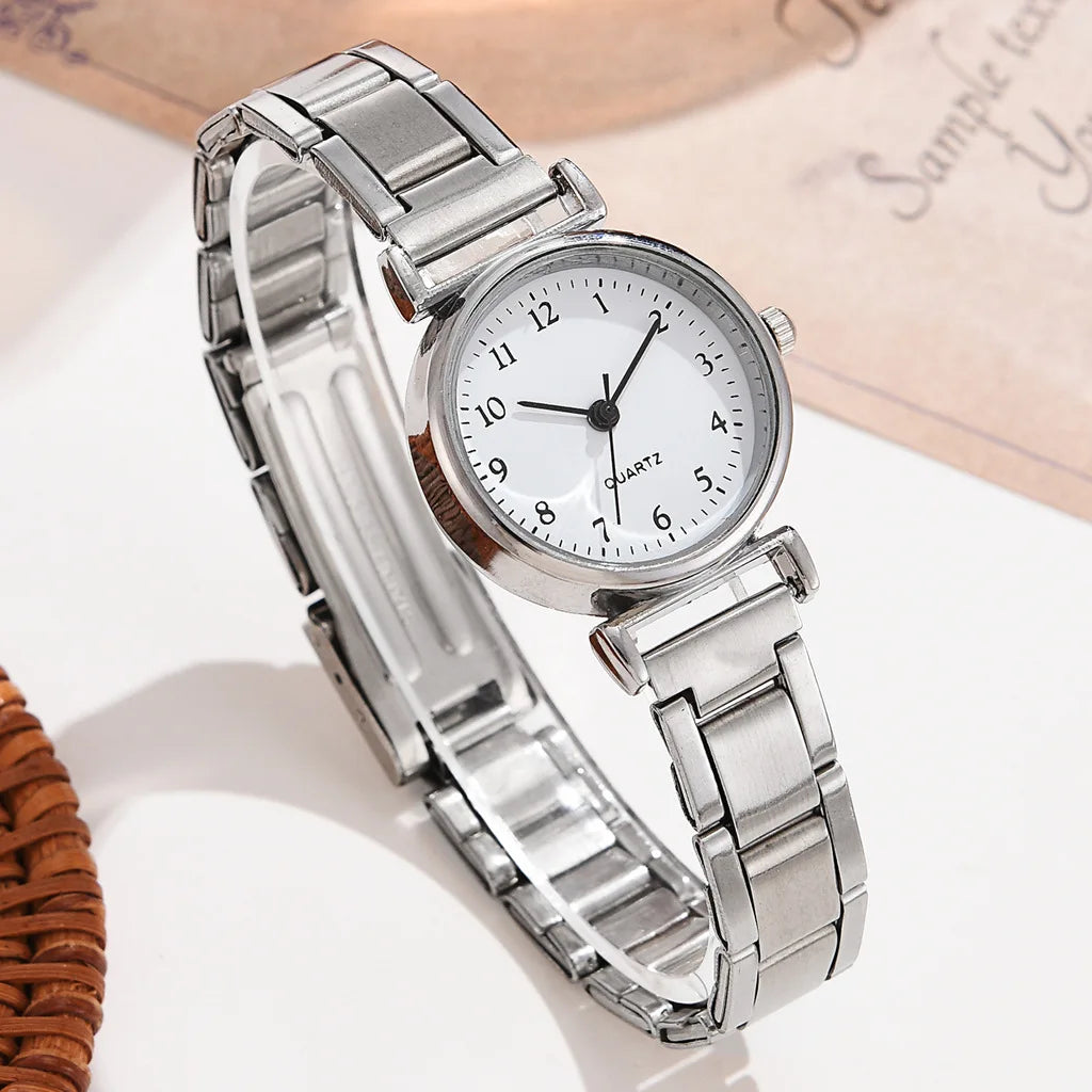 Silver wristwatch with a white dial on a light background