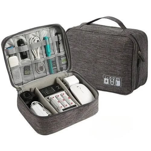 Gray travel organizer with electronic devices inside on a white background
