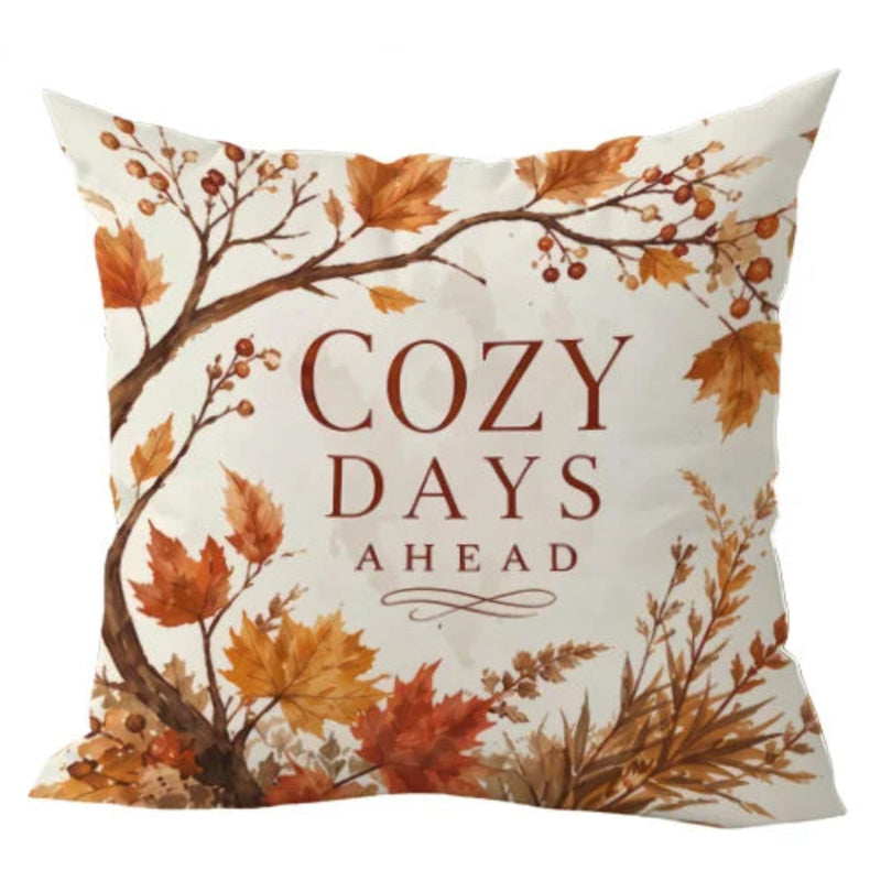 A square throw pillow with a 2D flat print design featuring autumn leaves and branches in orange, brown, and beige tones, with the text 'COZY DAYS AHEAD' printed in the center.