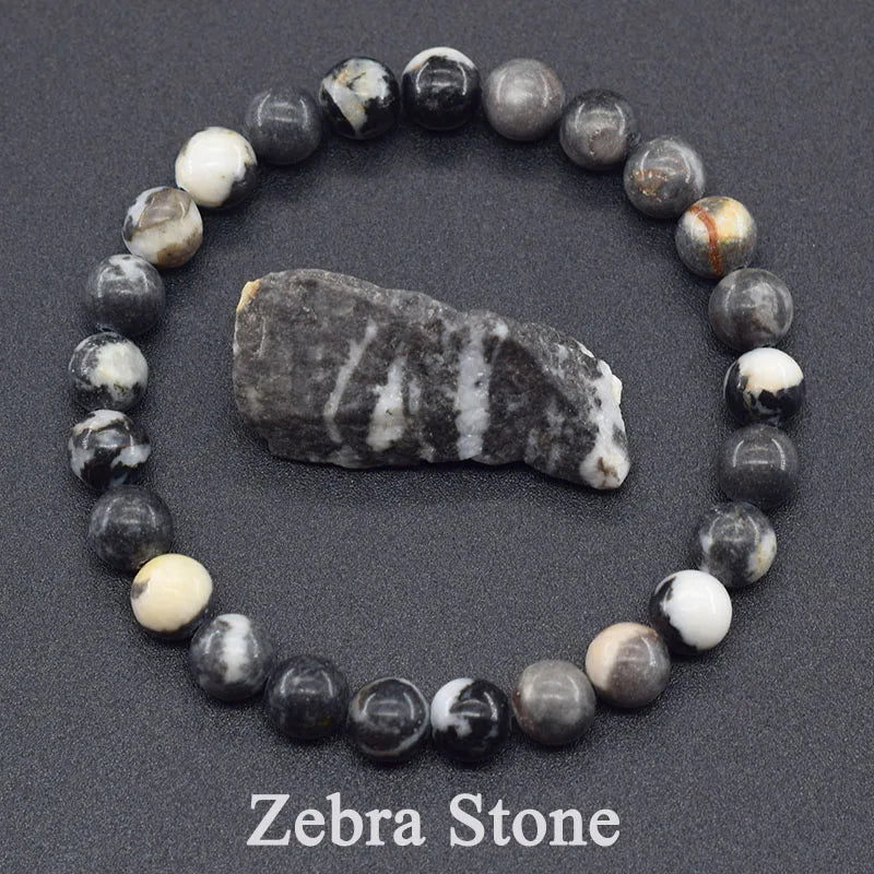 Zebra stone bracelet with a larger stone in the center on a dark background