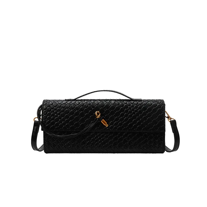 Black quilted handbag with a strap on a white background