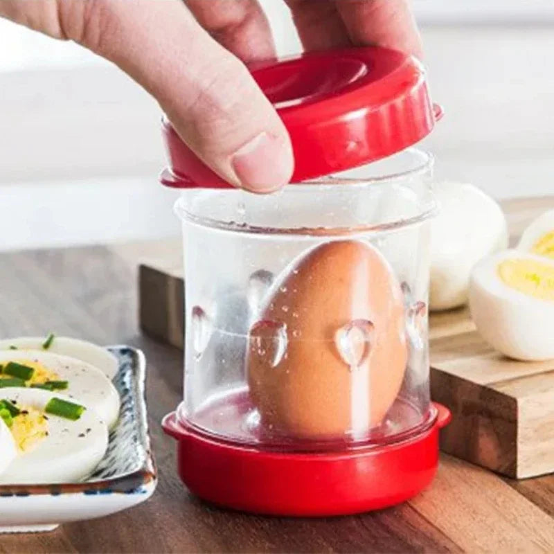 Egg in a glass container with a red lid on a wooden surface, surrounded by other eggs.
