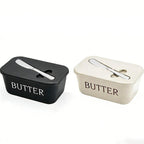 Two butter containers, one black and one white, on a white background.