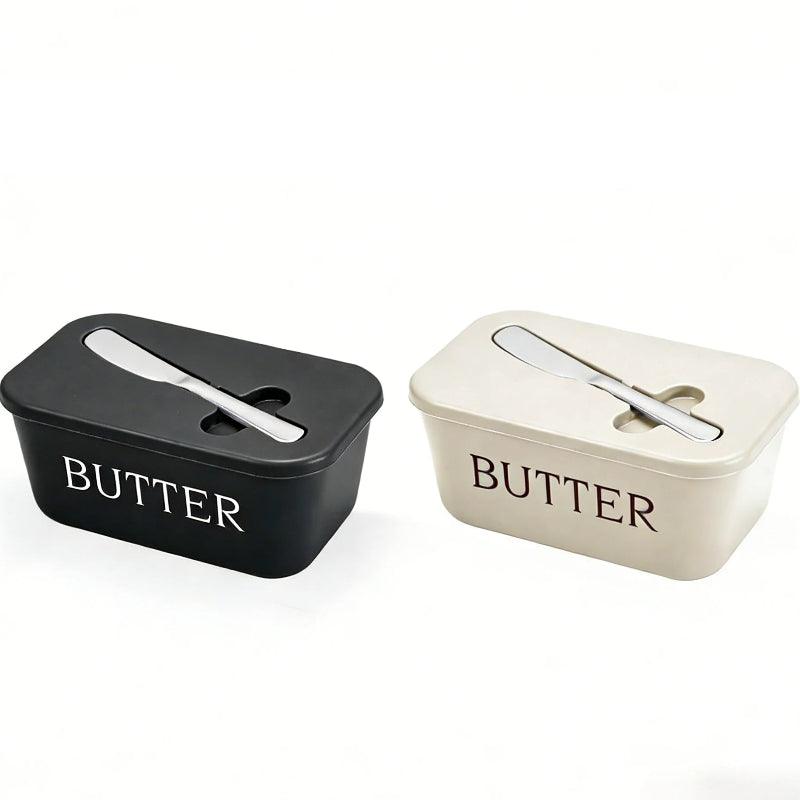 Two butter containers, one black and one white, on a white background.
