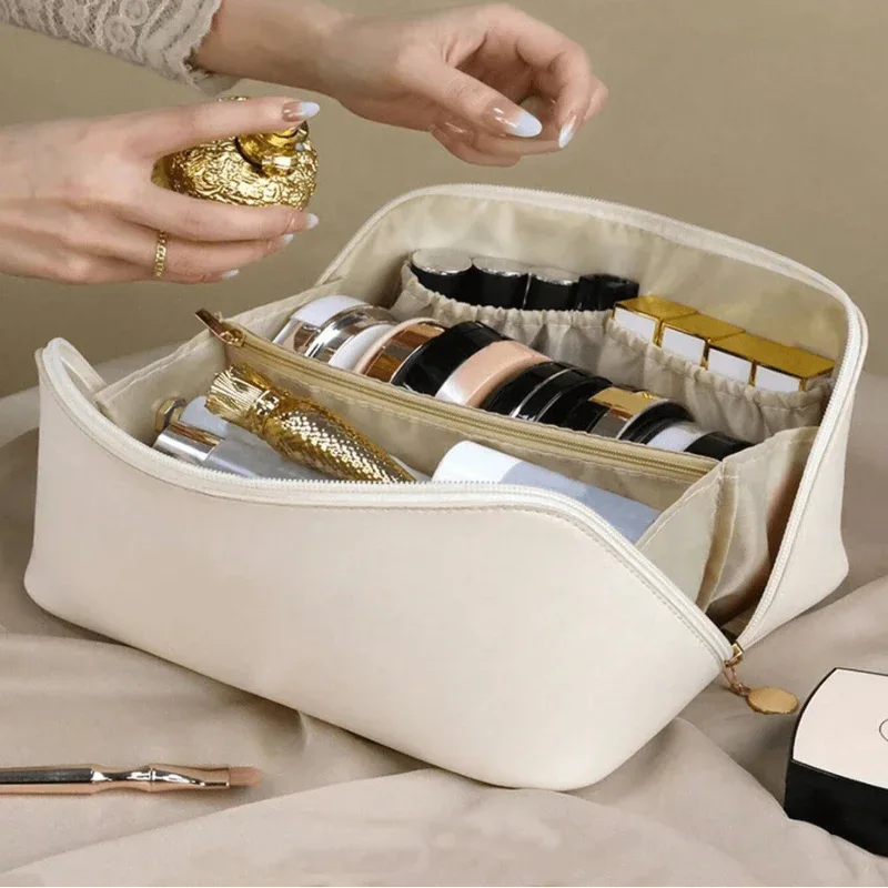 Beige jewelry organizer with gold and silver jewelry on a beige surface