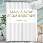 White shower curtain with 'Stain & Soap Scum Resistant' text and 'Premium PEVA' label, hanging in a bathroom.