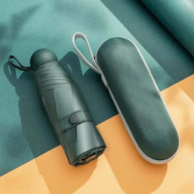 Green umbrella and its case on a colorful background