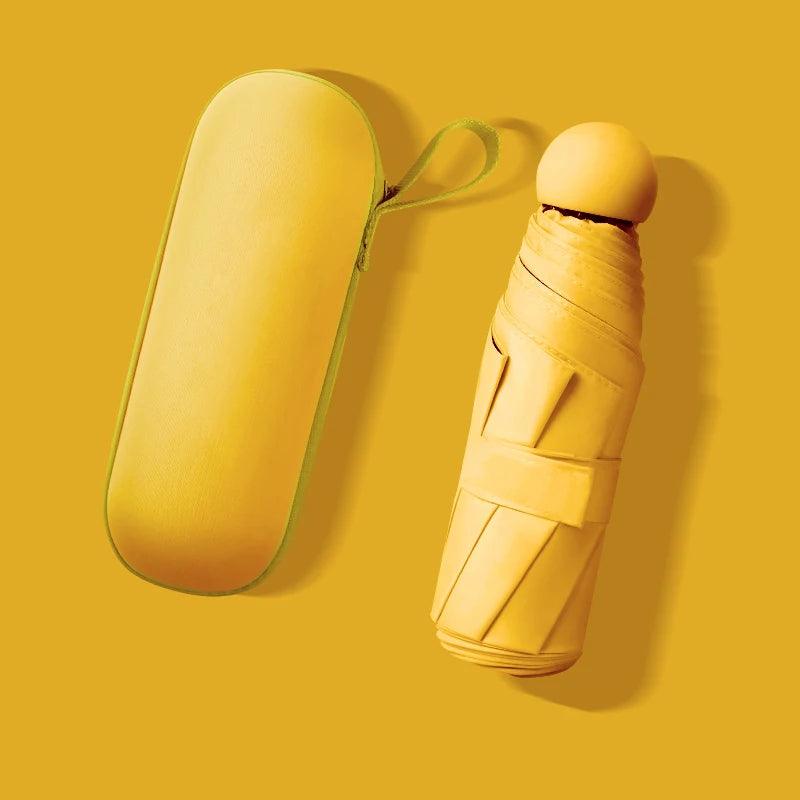Yellow umbrella and carrying case on a yellow background