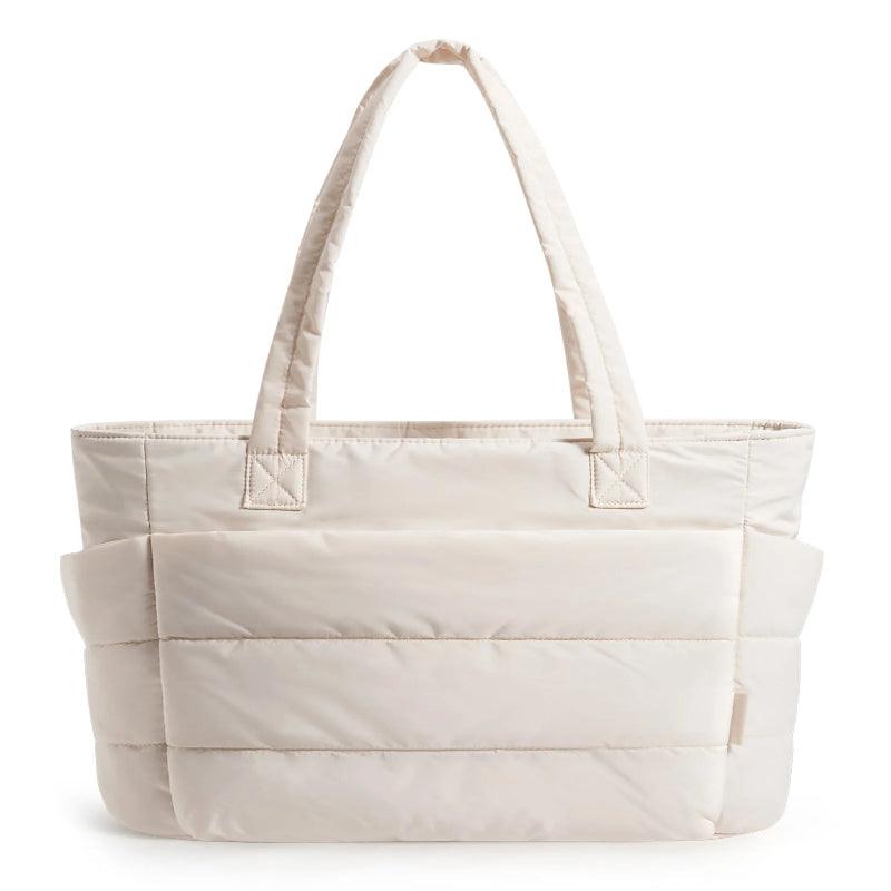 Beige tote bag with multiple compartments on a white background