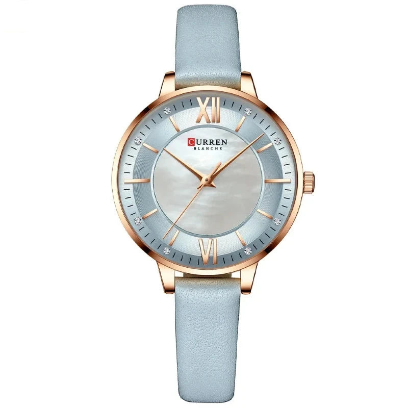 Curren watch with light blue strap and rose gold accents on a white background