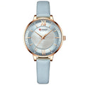 Curren watch with light blue strap and rose gold accents on a white background