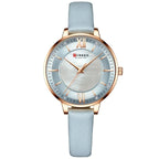 Curren watch with light blue strap and rose gold accents on a white background