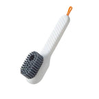 Cleaning brush with white handle, gray scrubber, and orange end on a white background
