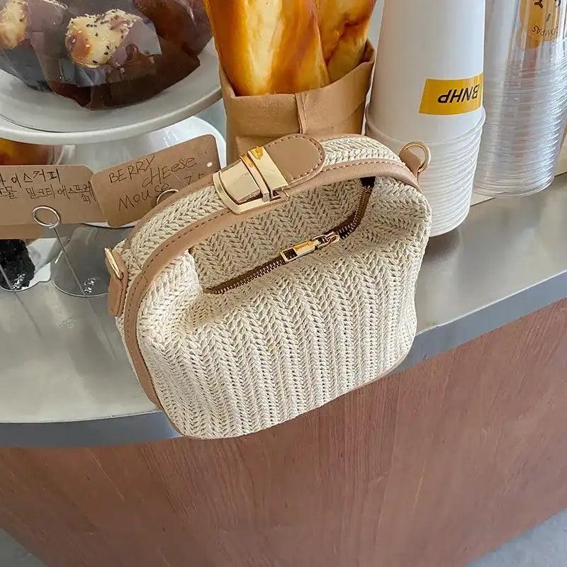 Woven handbag on a wooden surface with a blurred background