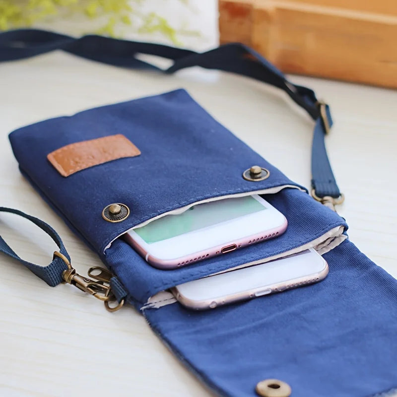 Blue crossbody bag with a phone inside on a light surface