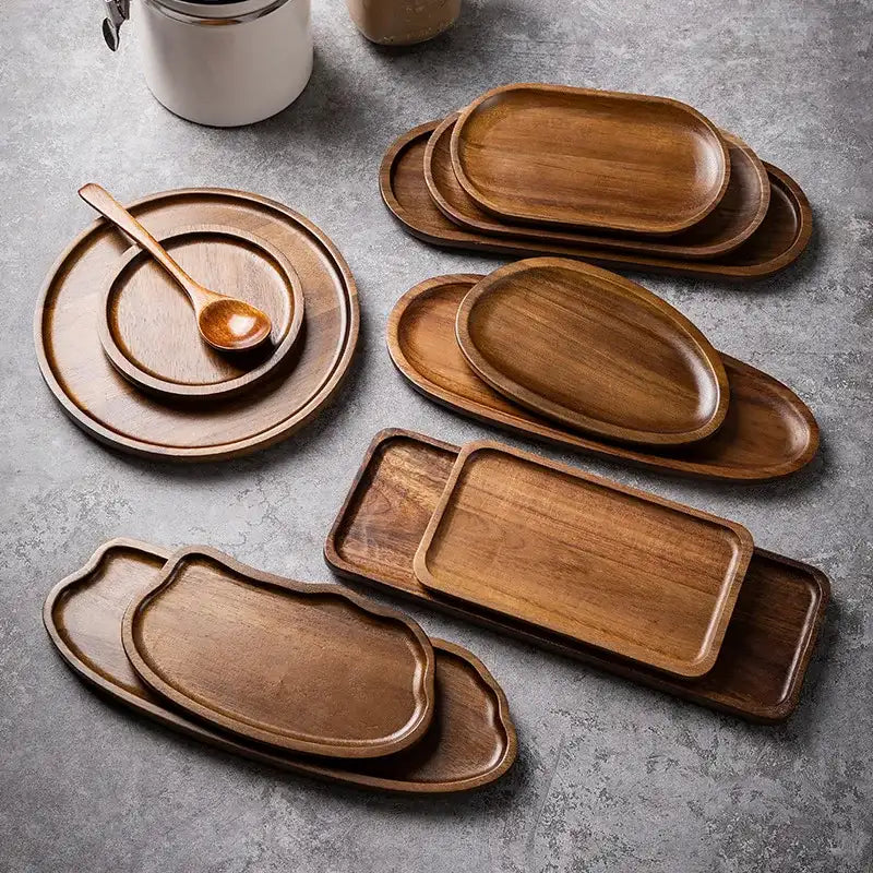 Set of wooden trays and plates on a gray surface