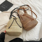 Two woven bags on a white surface with a book in the background.