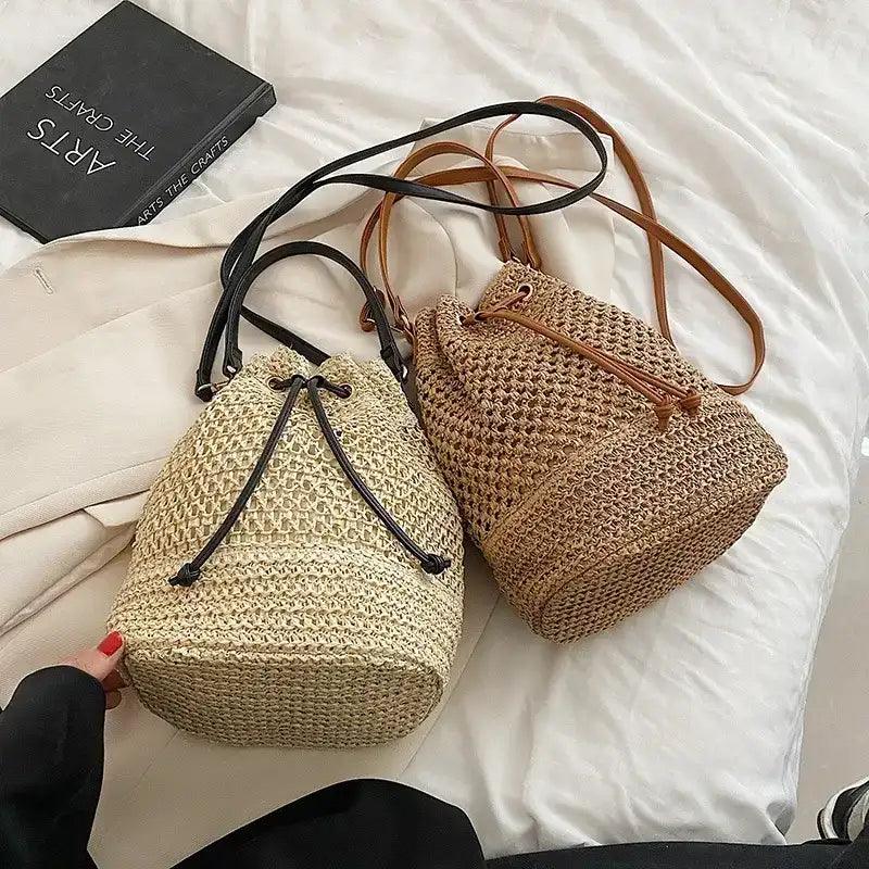 Two woven bags on a white surface with a book in the background.
