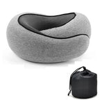 A gray contoured travel neck pillow with a black mesh interior, shown alongside its black drawstring storage pouch on a white background.