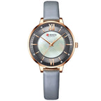 Curren watch with gray strap and rose gold case on white background