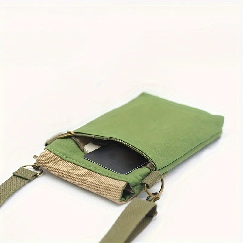 Green crossbody bag with a phone inside on a white background
