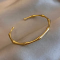 Gold bracelet on a beige fabric background