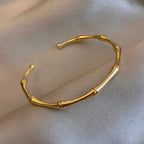 Gold bracelet on a beige fabric background