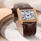 Elegant retro watch with brown leather strap on a marble surface