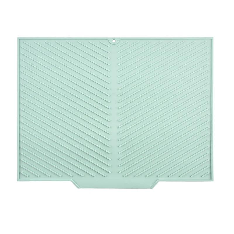 Mint green silicone baking mat with textured pattern on a white background