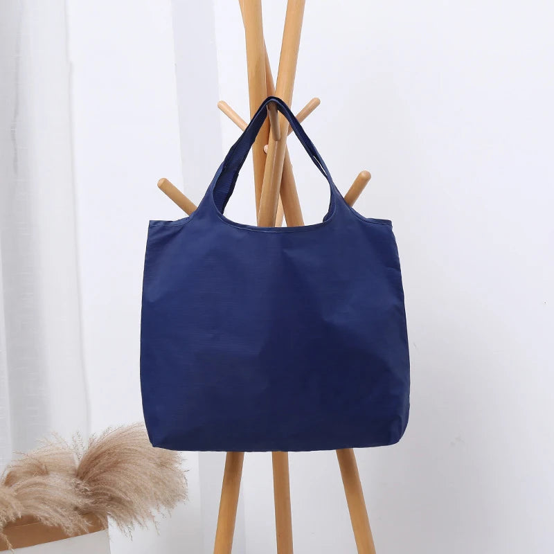 Blue tote bag on a light gray background