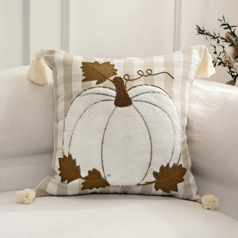 Decorative pillow with a pumpkin design on a couch