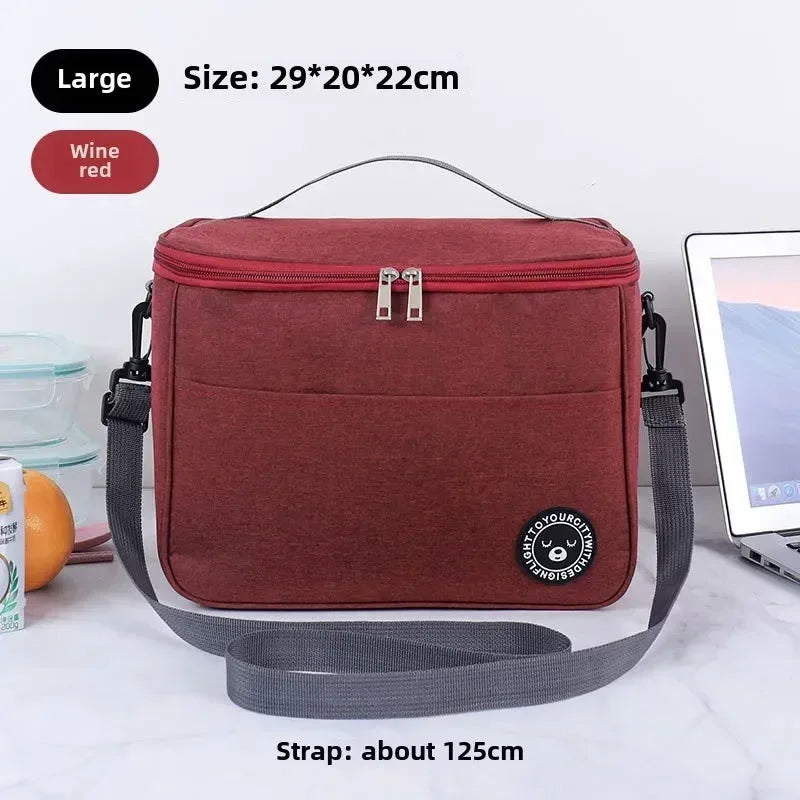 Burgundy insulated lunch bag with gray strap on a white background